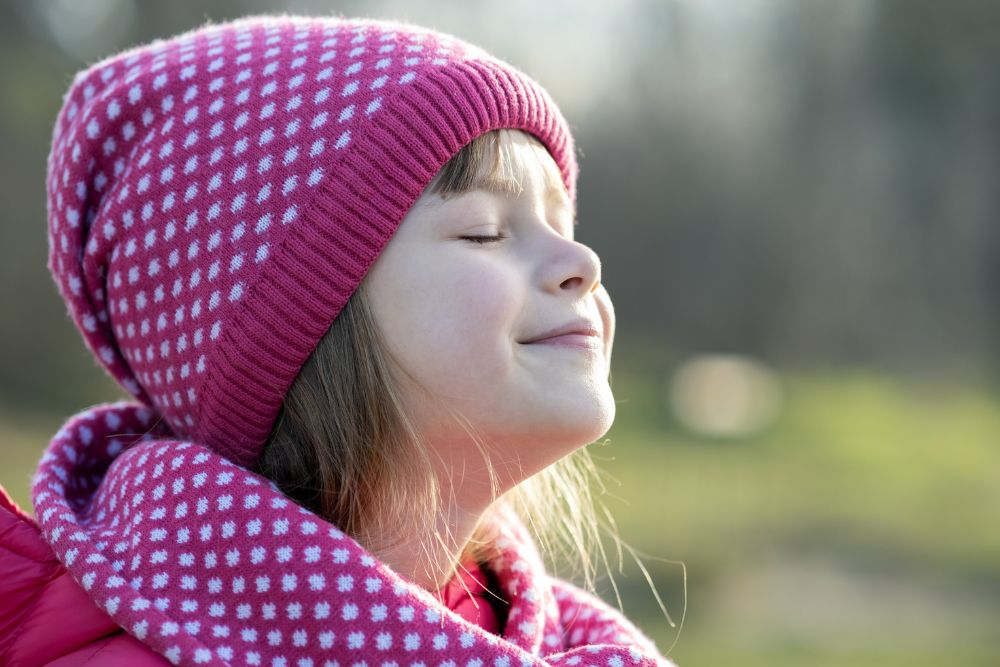 Child practicing mindful breathing